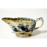 An 18thC blue and white porcelain sauceboat of small proportion, with shaped outline and ribbed