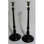 A pair of early 20thC mahogany candlesticks, with fluted and wrythen stems, 55cm high.