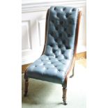 A Victorian mahogany nursing chair, with a blue leather buttoned back and seat, on turned legs