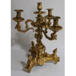 A Regency ormolu candelabrum, with three acanthus capped scrolling arms, with ram's mask terminals