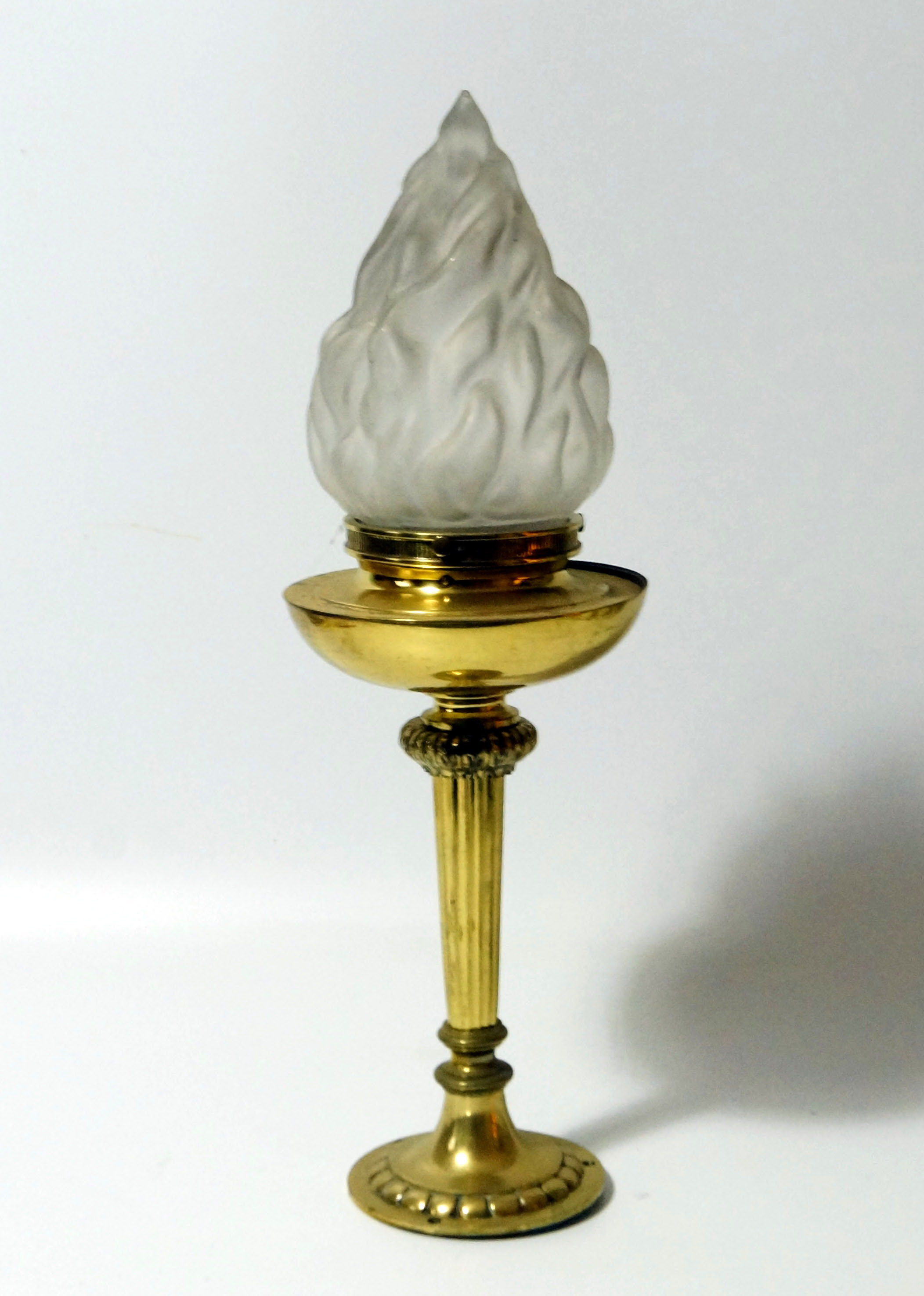 A brass torch form table lamp, 46cm high.