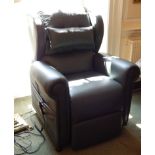 A modern dark green leather electric reclining armchair, on castors.