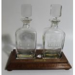 A late 20thC kingwood decanter stand, by Laurence Ganney, inset with two engraved decanters