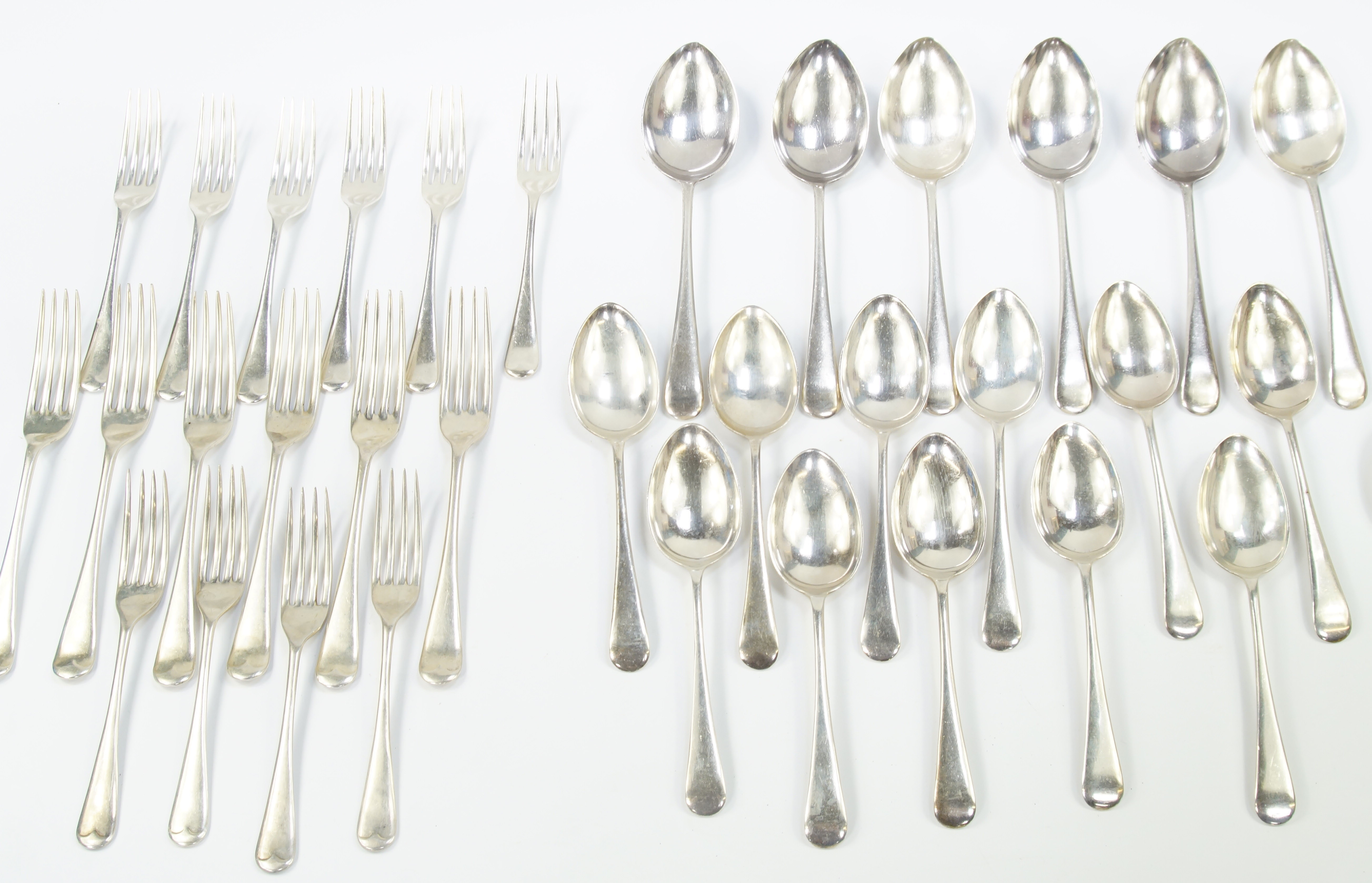 A quantity of George V silver flatware, decorated in the Old English pattern, comprising six serving