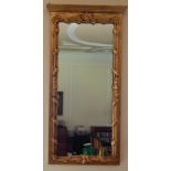 A pair of gilt gesso wall mirrors, each with a moulded cornice, a rectangular plate surrounded by