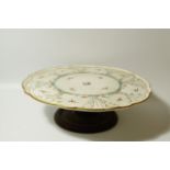 A Victorian porcelain Lazy Susan, of Aesthetic design, (AF) on a mahogany pedestal, 56cm dia.