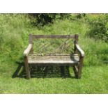 A pair of hardwood garden benches, with Chinese lattice back, 116cm wide.