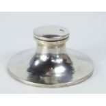 A George V silver capstan inkwell, Birmingham 1918, the hinged cover bearing inscription, with oak