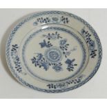 An 18thC English tin glazed earthenware Delft plate, the circular body centred by flowerheads with a