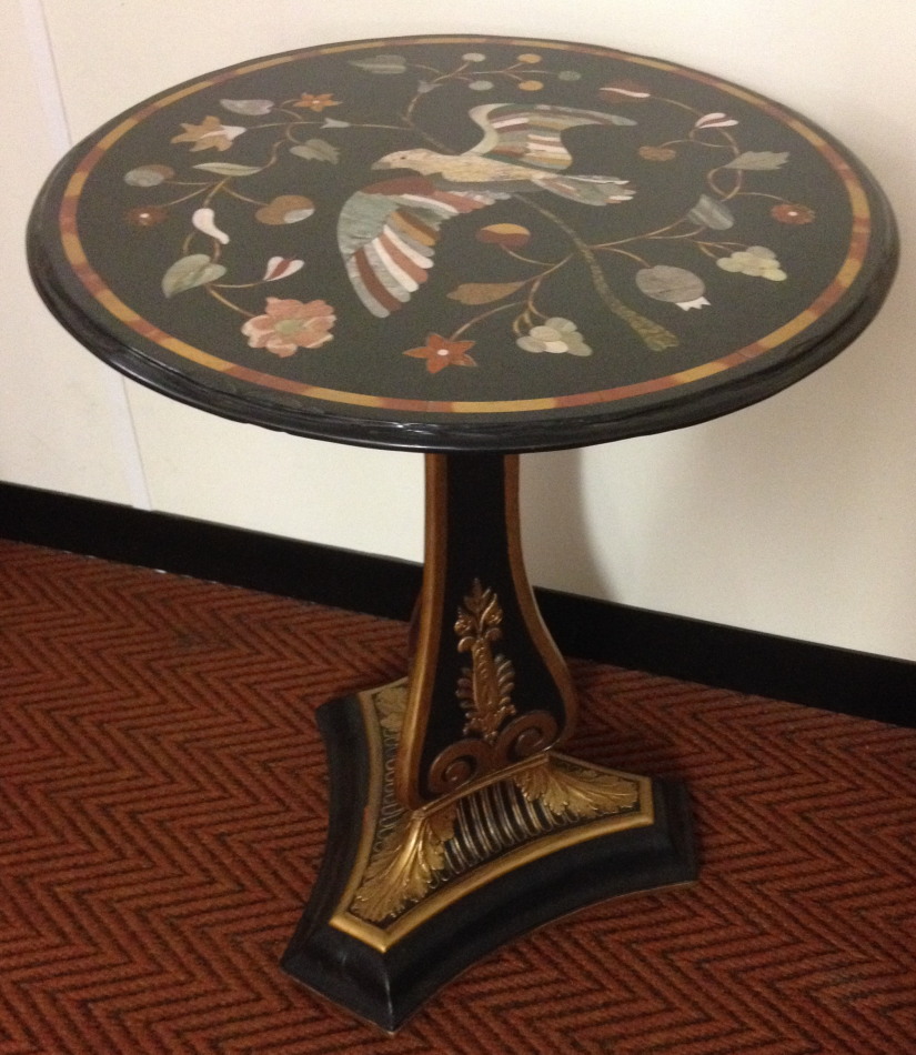 A parcel gilt and ebonised pedestal table, with pietra dura specimen marble top