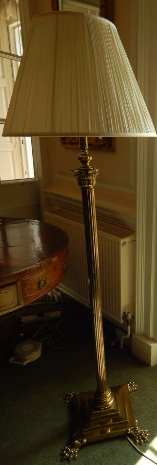 An early 19thC brass floor lamp, with a reeded Corinthian column, the square base applied with