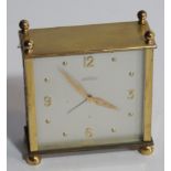 A modern gilt metal timepiece by Angelus, the square case with ball finials, enclosing a silvered