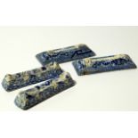 Two pairs of 19thC blue and white pottery knife rests, each of shaped rectangular outline, one