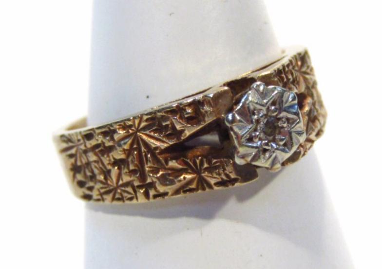 A ladies 9ct gold solitaire ring, the textured part pierced shank centred by a single stone, size I,