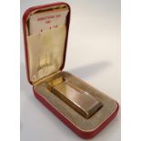 A mid-20thC Dunhill pocket lighter, in part engine turned gilt metal, 7cm high, in fitted box.