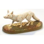 An early 20thC Crown Devon Fieldings figure, of a fox, standing in white with brown highlights on