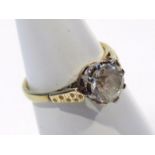 A ladies solitaire ring, with a single claw set stone on a part pierced shank, unmarked yellow