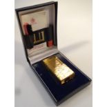 A mid-20thC Dunhill pocket lighter, 7cm high, in textured gold case and outer box.