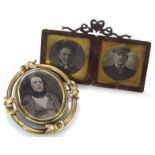 An Edwardian memorial brooch, the plain oval band outline broken by scrolls centred with a