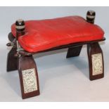 A 20thC camel stool, with red leatherette top, surmounted by cylindrical handles, inlaid and