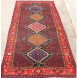 A Lori runner, in medallion blue and red, 336cm x 165cm.