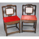 A pair of early 20thC Chinese hardwood chairs, each with a marble coloured centre splat flanked by