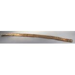 A heavily carved early 20thC native Australian didgeridoo, the shaped cylindrical body naively