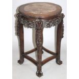 A Japanese Meiji period hardwood jardiniere stand, the shaped circular top centred by a section of