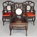 A set of three 20thC Chinese hardwood armchairs, each with pierced splats centred by marble coloured