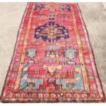 A Lori runner, in medallion red and red, 322cm x 170cm.