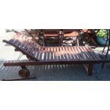 A hardwood slatted garden lounger, 190cm long.