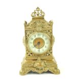A late 19thC brass cased mantel clock, brass dial and white enamel chapter ring bearing Arabic