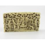 A Cantonese late 19thC ivory card sleeve, carved with figures in a garden, 7cm x 3.5cm, (AF).