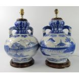 A pair of modern Chinese porcelain table lamps, of twin handled baluster form decorated in blue