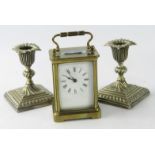 A brass carriage clock, white enamel dial bearing Roman numerals, with key, 8cm x 6cm x 14.5cm,