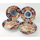 A pair of Qing Dynasty Imari scallop shell dishes, decorated with gardens, and two fluted dishes