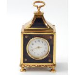 A George V silver gilt and tortoiseshell boudoir clock, circular white enamel dial bearing Arabic