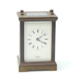 A brass carriage clock by St James London, white enamel dial bearing Roman numerals, with key, 8cm x