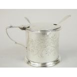 A Victorian silver mustard pot, the barrel shaped body with thumb caped shell handle hinged lid,