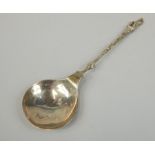 A Continental silver gilt spoon, the handle with an apostle type finial of a female figure and two