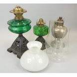 Various oil lamps, to include two Victorian examples with cast iron bases and green glass