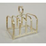 A silver four division toast rack, of faceted form, Birmingham 1905, 2¼oz.