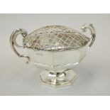 A George V silver two handled rose bowl, by Walker and Hall, with mesh grill, the hexagonal base, on