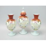 A Victorian opaque glass garniture, each decorated in raised enamels with flowers, leaves,