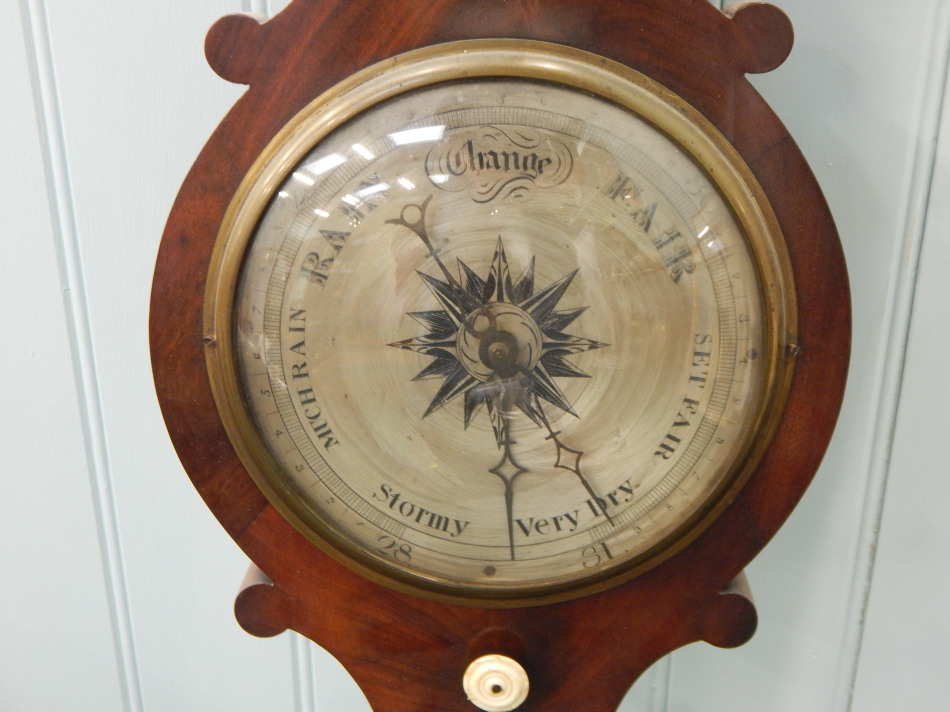 A Victorian wheel barometer by Puibus, in a figured mahogany case, 104cm long. (AF) - Image 2 of 2