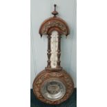 A late Victorian walnut wheel barometer, with later aneroid barometer insert, and a thermometer,