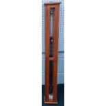 A mid 20thC ship's barometer, with metal fittings, in a glazed teak case, 118cm long.