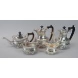 A Victorian silver five piece tea set, each piece cast with shells, scrolls etc, and with repousse