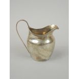 A Victorian silver cream jug, with a reeded band, loop handle, London 1872, 3½oz.