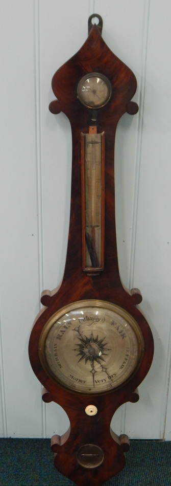 A Victorian wheel barometer by Puibus, in a figured mahogany case, 104cm long. (AF)